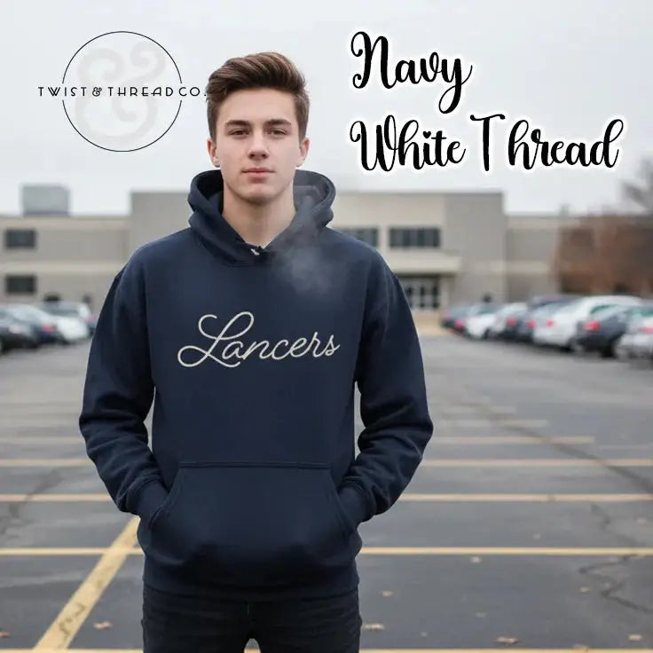 Young man wearing navy hoodie with white 'Lancers' script, standing in parking lot on a cold day