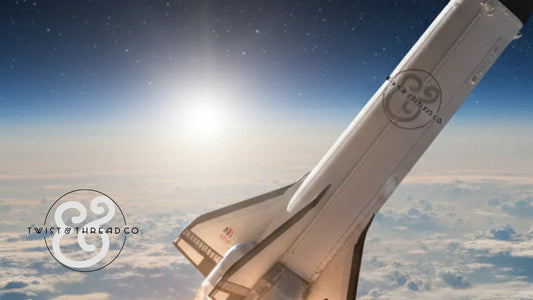 Space shuttle with Twist & Thread Co. logo above Earth and clouds, sunrise in background