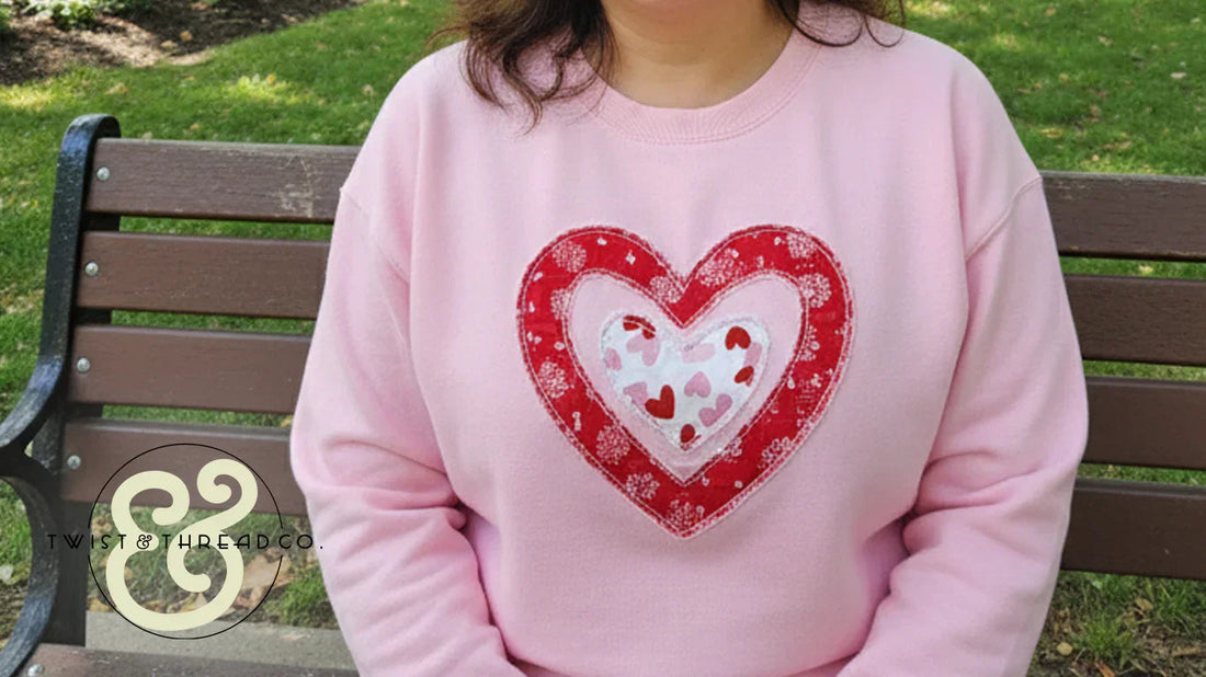 Woman in pink sweatshirt with embroidered red and white heart, Twist & Thread Co. apparel