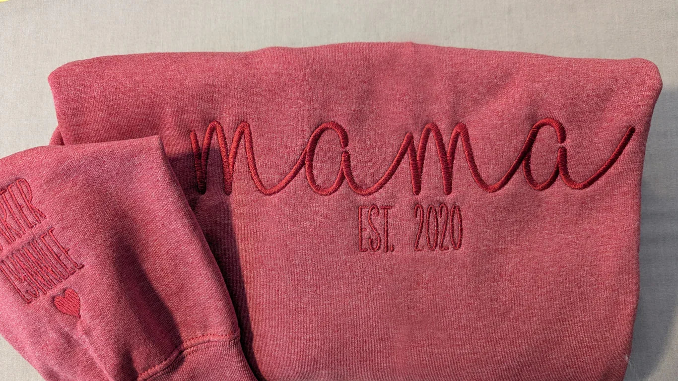 Rose pink embroidered sweatshirt reading 'mama EST. 2020,' premium custom apparel by Twist & Thread Co.