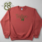 Red crewneck sweatshirt with green embroidered text "Festive AF" and Twist & Thread Co. logo
