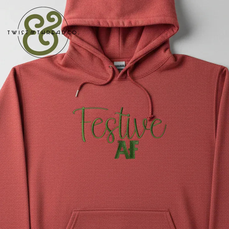 Rust-colored hoodie with green embroidered text saying Festive AF by Twist & Thread Co.