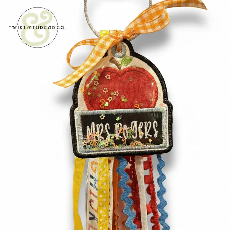 Personalized teacher bag tag with apple design, glitter stars, and colorful ribbons for Mrs Rogers