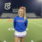 Smiling cheerleader in blue Bears Cheer sweatshirt and skirt on football field, Twist & Thread Co. apparel