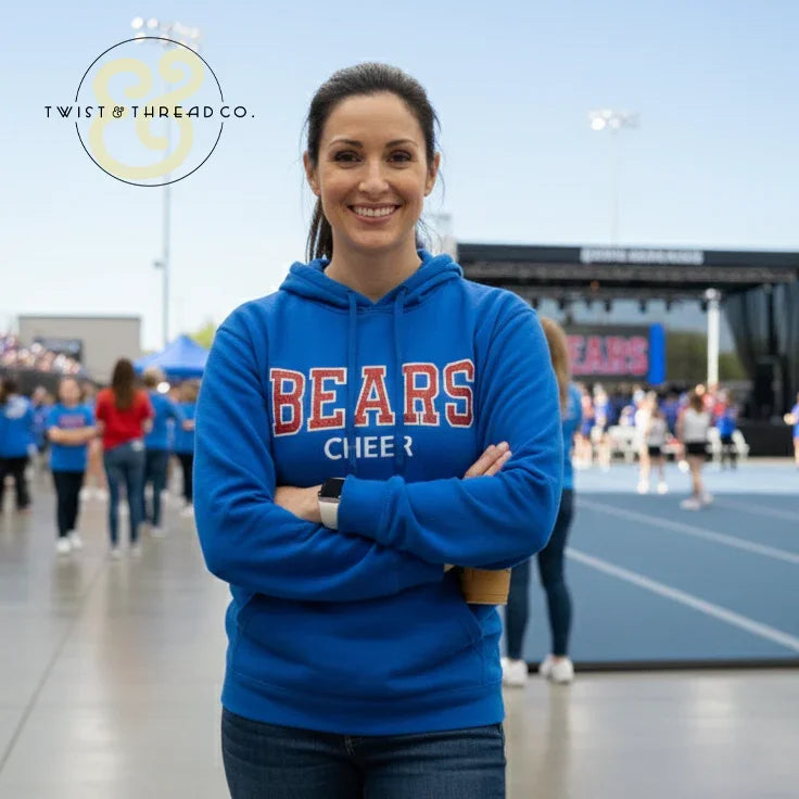 Smiling woman in blue BEARS CHEER hoodie at cheer event, Twist & Thread Co. embroidered apparel