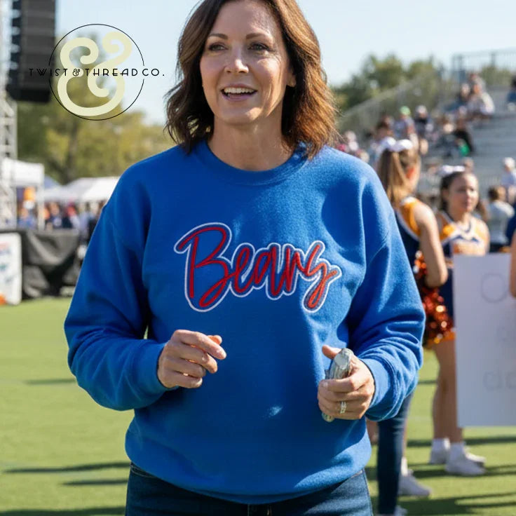 Woman wearing blue Bears embroidered sweatshirt at outdoor event, Twist & Thread Co.