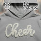 Gray Gildan hoodie with white yarn 'Cheer' text, Ash White Yarn by Twist & Thread Co.