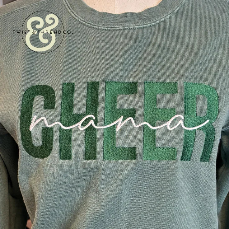 Green sweatshirt with embroidered bold 'CHEER' and cursive 'mama' text, premium custom apparel