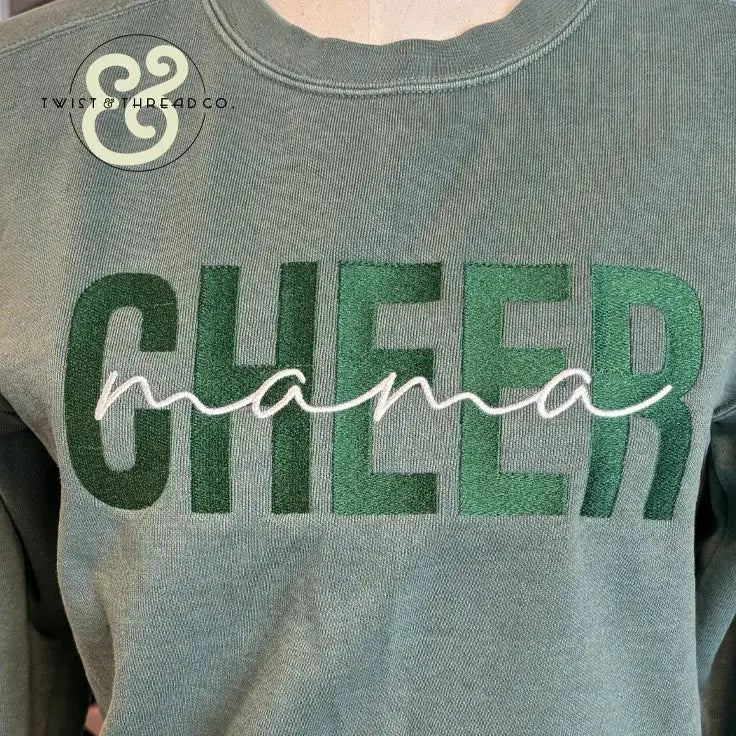 Green sweatshirt with embroidered bold 'CHEER' and cursive 'mama' text, premium custom apparel