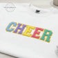 White sweatshirt with colorful chenille CHEER letters, Twist & Thread Co. branding, flat lay