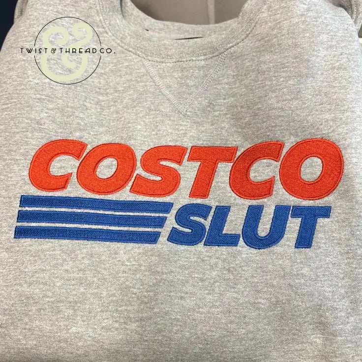 Gray custom embroidered sweatshirt with bold red and blue text, Twist & Thread Co. branding