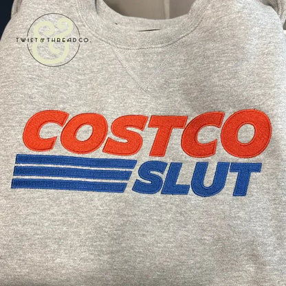 Gray custom embroidered sweatshirt with bold red and blue text, Twist & Thread Co. branding