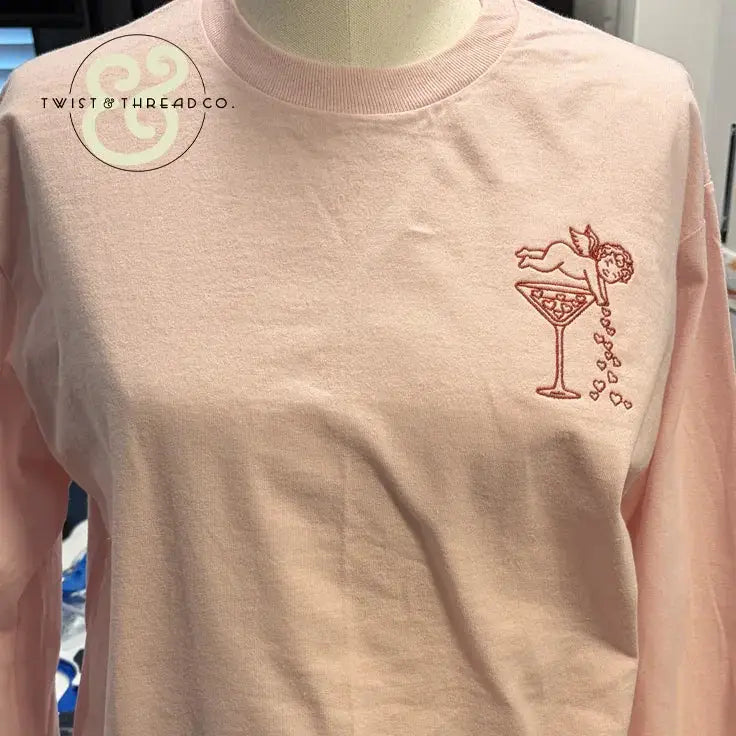 Pink embroidered shirt from Twist & Thread Co. with cupid and martini glass heart design