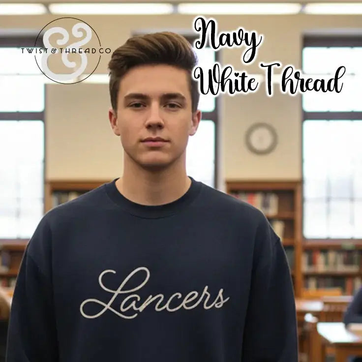 Young man wearing navy sweatshirt with white thread Lancers text in library setting