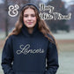 Smiling woman outdoors wearing navy hoodie with white thread 'Lancers' text and Twist & Thread Co logo