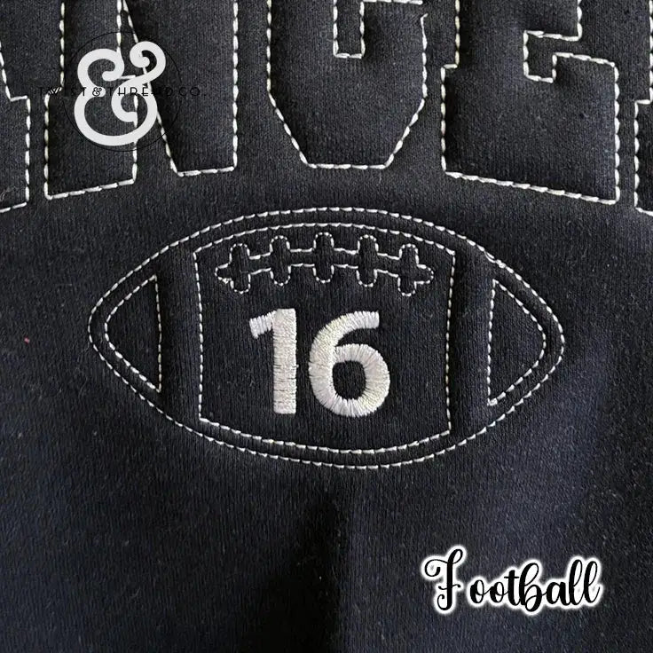 Black fabric with white stitched football design and number 16, sports sweatshirt detail