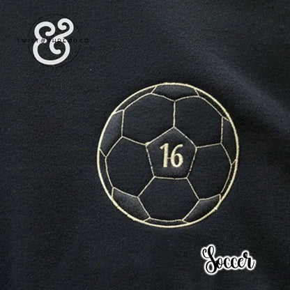 Black fabric with embroidered soccer ball and number 16, Twist & Thread Co. logo