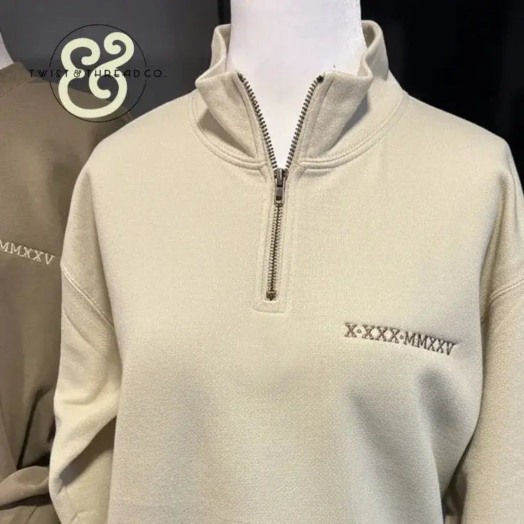 Embroidered beige quarter-zip pullover with Roman numerals, Twist & Thread Co. apparel