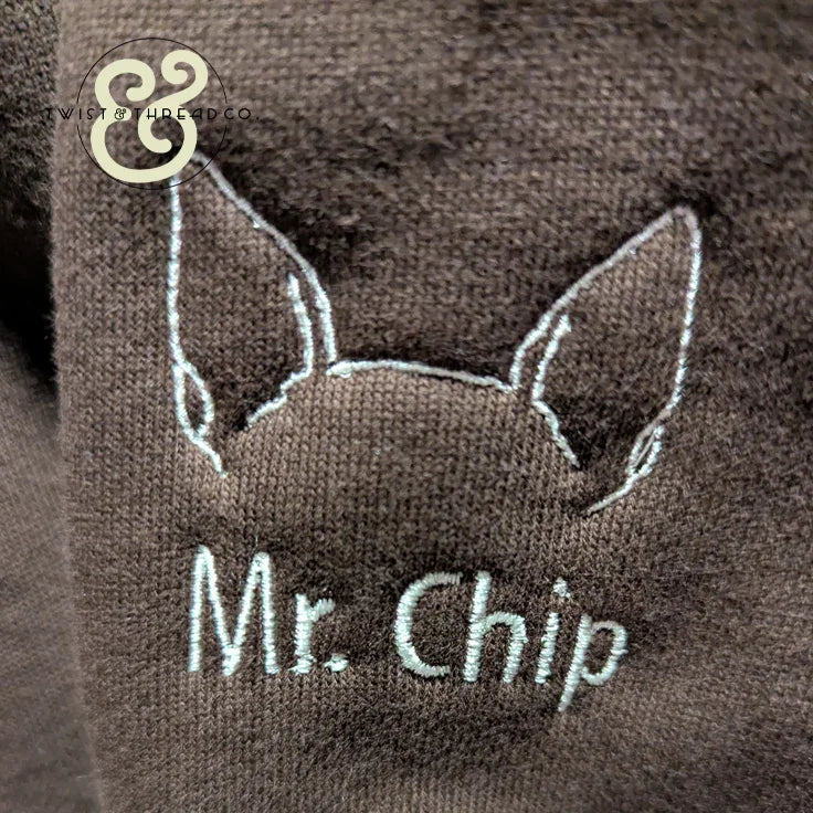 Custom dog ear embroidery with 'Mr. Chip' text on brown hoodie by Twist & Thread Co.