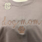 Custom embroidered hoodie with 'dog mom' and paw print by Twist & Thread Co.