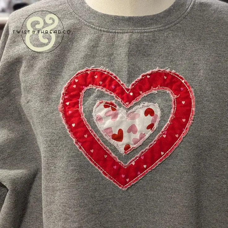 Gray sweatshirt with red and white embroidered heart applique by Twist & Thread Co.