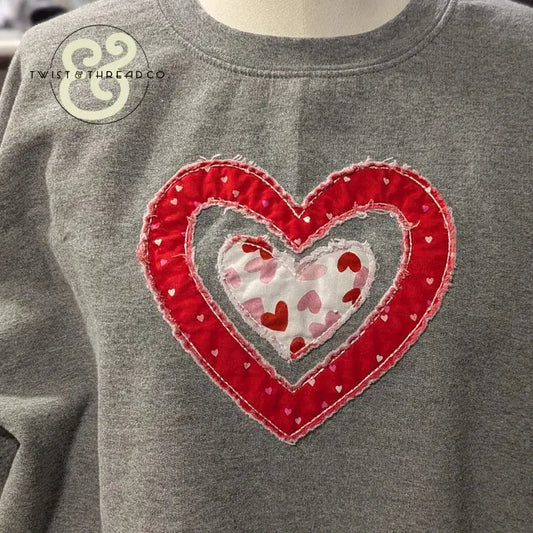 Gray sweatshirt with red and white embroidered heart applique by Twist & Thread Co.