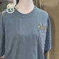 Blue pocket t-shirt with colorful floral embroidery, Twist & Thread Co. custom apparel