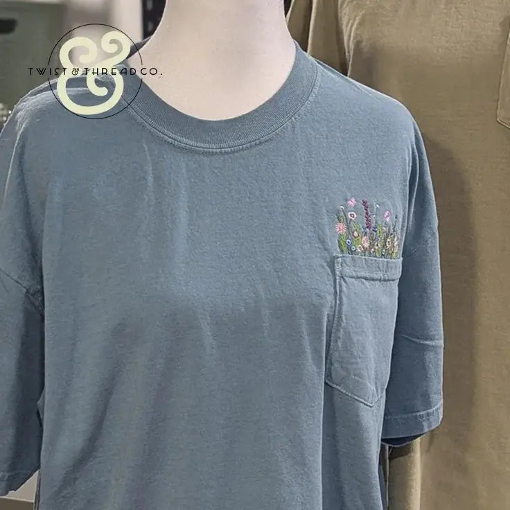 Blue pocket t-shirt with colorful floral embroidery, Twist & Thread Co. custom apparel