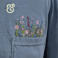 Blue hoodie with custom embroidered wildflowers on pocket from Twist & Thread Co.