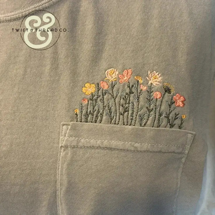 Custom embroidered wildflowers on a pocket tee by Twist & Thread Co.