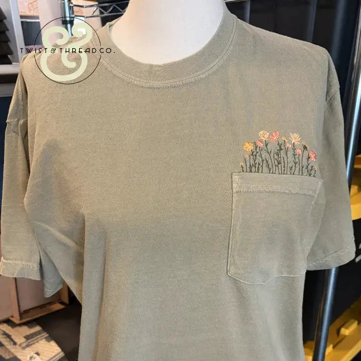 Custom embroidered pocket tee with floral design by Twist & Thread Co.