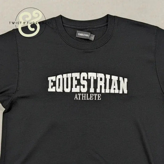 Black embroidered sweatshirt with white text reading Equestrian Athlete by Twist & Thread Co.