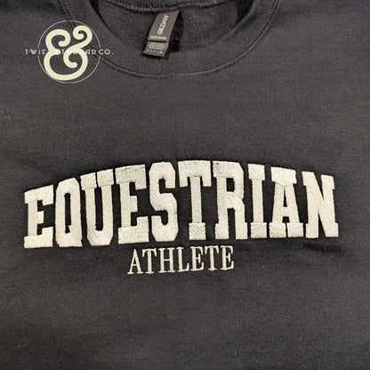 Black heavy blend sweatshirt with white embroidered text EQUESTRIAN ATHLETE by Twist & Thread Co.