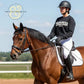 Equestrian athlete in black Twist & Thread Co. sweatshirt riding a bay horse in outdoor arena