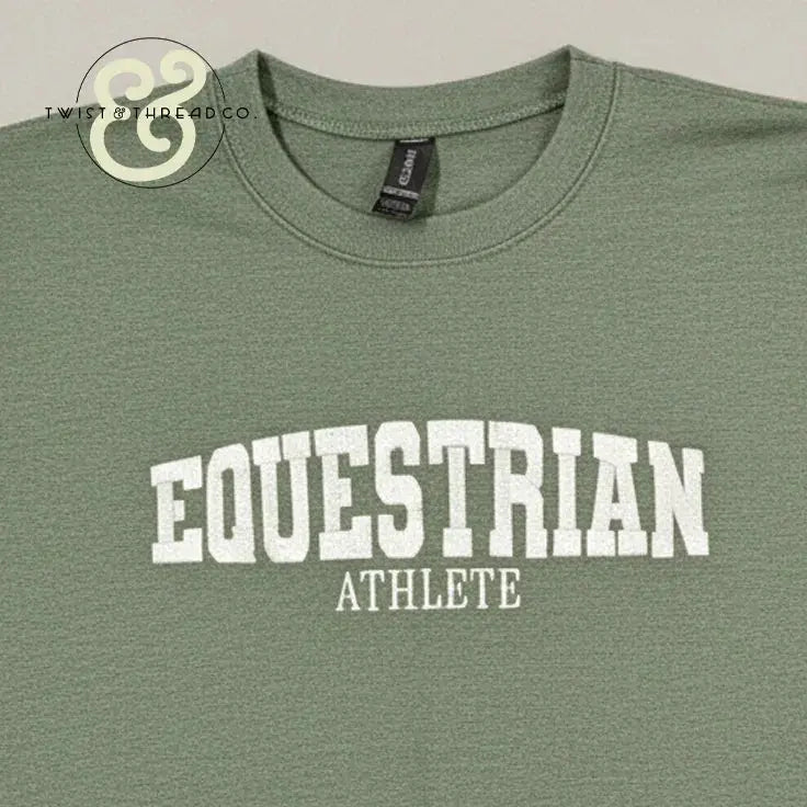 Green crewneck T-shirt with white collegiate text reading 'EQUESTRIAN ATHLETE' from Twist & Thread Co.