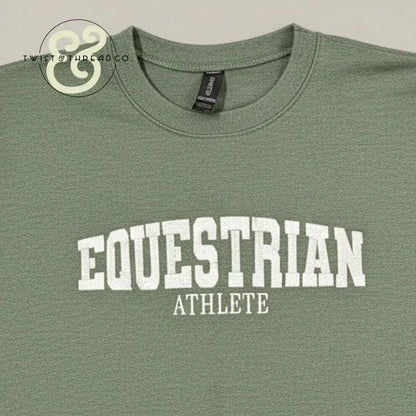 Green crewneck T-shirt with white collegiate text reading 'EQUESTRIAN ATHLETE' from Twist & Thread Co.