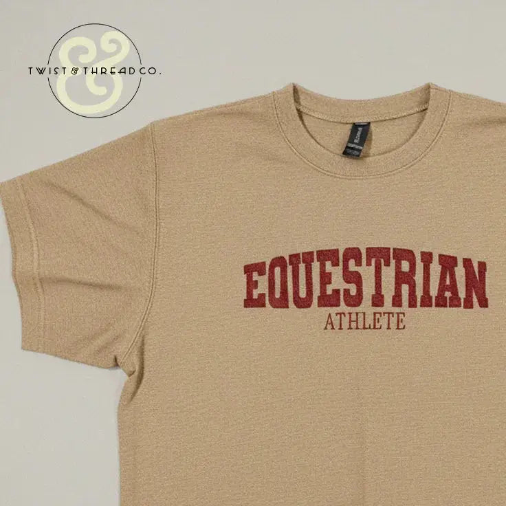 Beige embroidered t-shirt with bold red text reading 'EQUESTRIAN ATHLETE' from Twist & Thread Co.