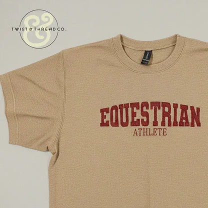 Beige embroidered t-shirt with bold red text reading 'EQUESTRIAN ATHLETE' from Twist & Thread Co.