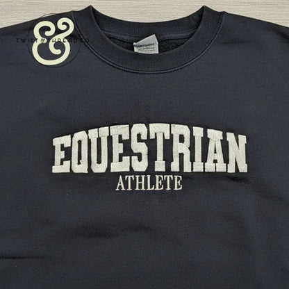 Black crewneck sweatshirt with embroidered text 'EQUESTRIAN ATHLETE' in white, premium apparel from Twist & Thread Co.