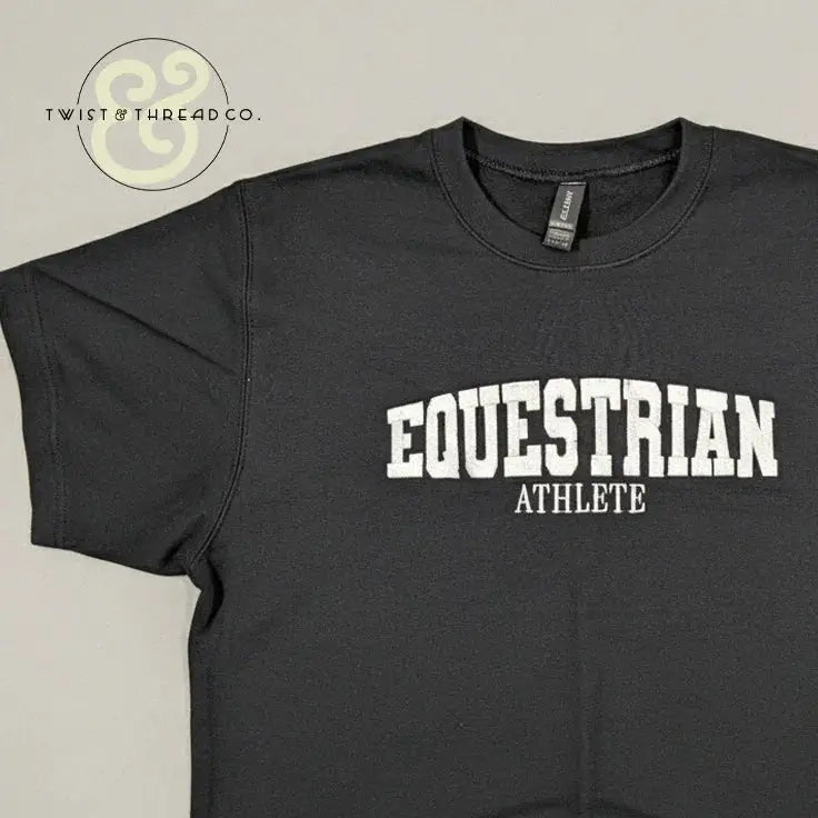 Black embroidered t-shirt with bold white text 'EQUESTRIAN ATHLETE' by Twist & Thread Co.