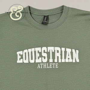 Green crewneck T-shirt with white collegiate text reading 'EQUESTRIAN ATHLETE' from Twist & Thread Co.