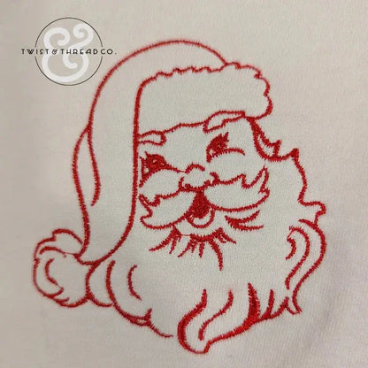 red embroidered Santa Claus face on white fabric with Twist & Thread Co. logo
