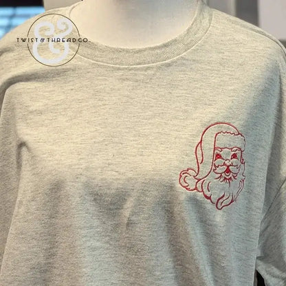 light gray sweatshirt with red embroidered vintage Santa Claus face on chest