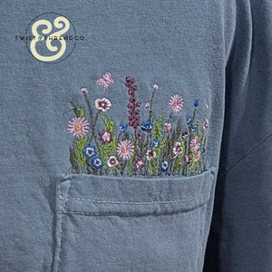 Blue hoodie with custom embroidered wildflowers on pocket from Twist & Thread Co.