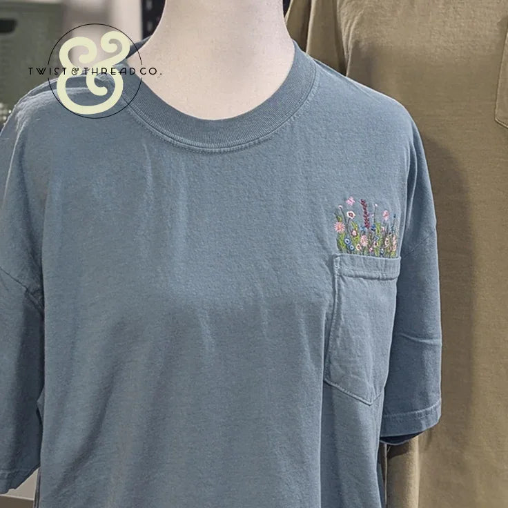 Blue pocket t-shirt with colorful floral embroidery, Twist & Thread Co. custom apparel