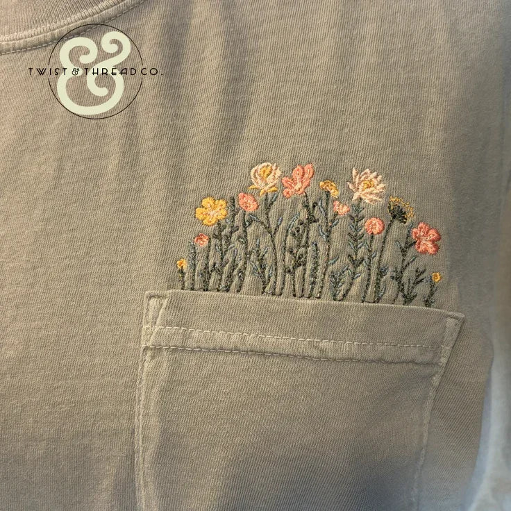 Custom embroidered wildflowers on a pocket tee by Twist & Thread Co.