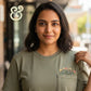 Woman in olive green custom embroidered t-shirt with floral pocket by Twist & Thread Co.