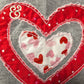 Heart applique embroidery with red and pink hearts on gray fabric, Twist & Thread Co. design.