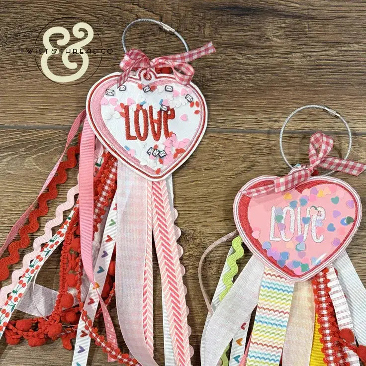 Embroidered heart-shaped LOVE ornaments with colorful ribbons and confetti, Twist & Thread Co.