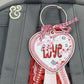 Embroidered heart-shaped LOVE keychain with red and pink ribbons by Twist & Thread Co.